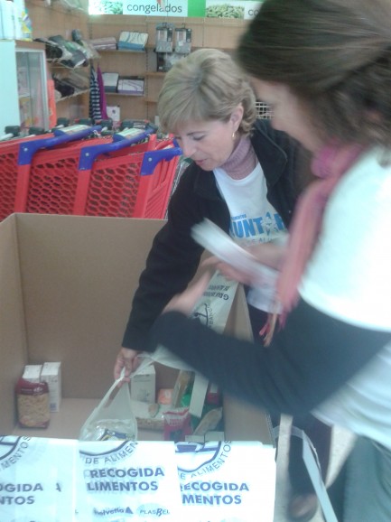 Two volunteers in my local supermarket accept food donated by shoppers as part of La Gran Recogida early this morning.