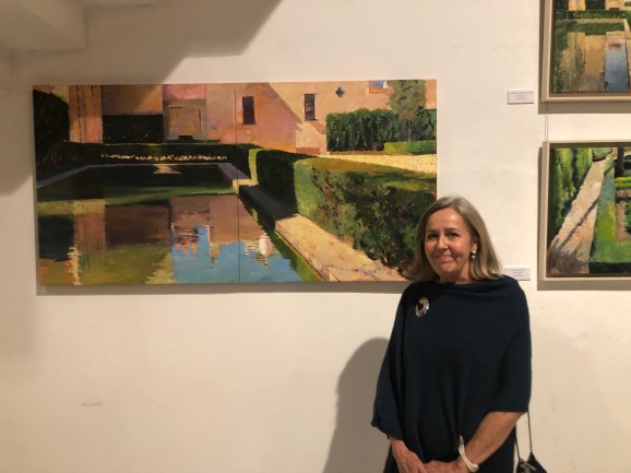 Artist Jill Roland Gosselin with some of her paintings,