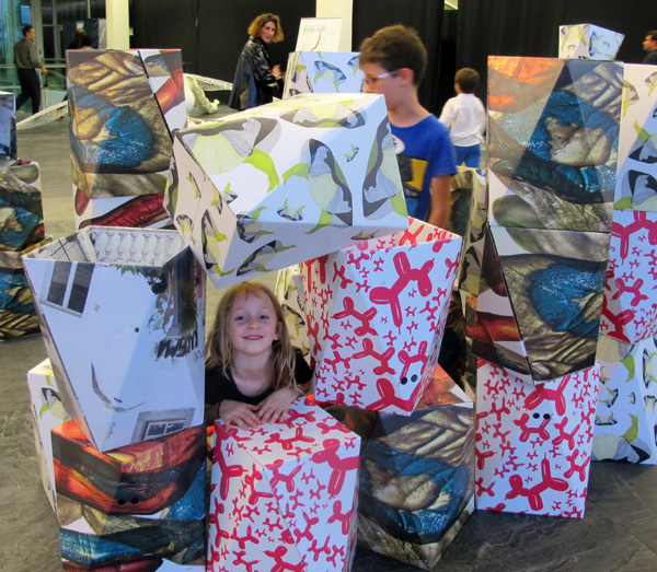 Using the cardboard taburetes (stools) as building blocks.