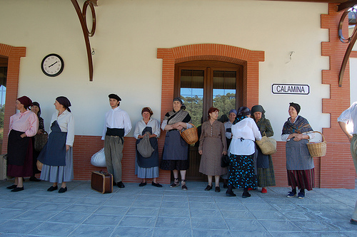 A group of townspeople wait at the train station. Photo: Javier Polo