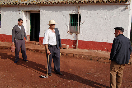 A still from on location: the father (centre) confronts his brother (right) outside the house which is the subject of family conflict. Photo: Javier Polo