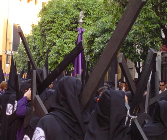 Semana Santa procession in Seville: penitentes with crosses.