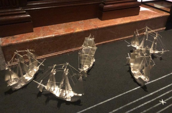 Model ships follow timelines along the floor, marking their progress and inclusion (or not) in the fleet.