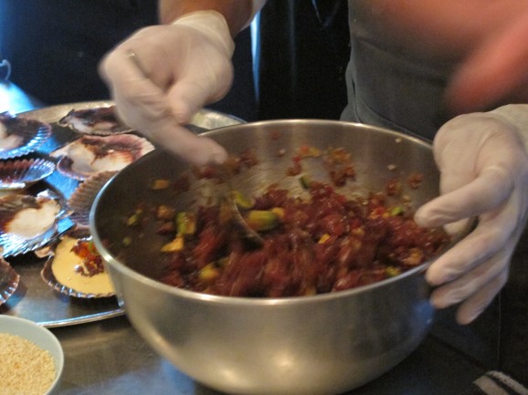 Mixing the tuna with avocado.