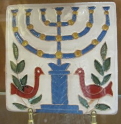 Ceramic tile showing the Menorah lamp