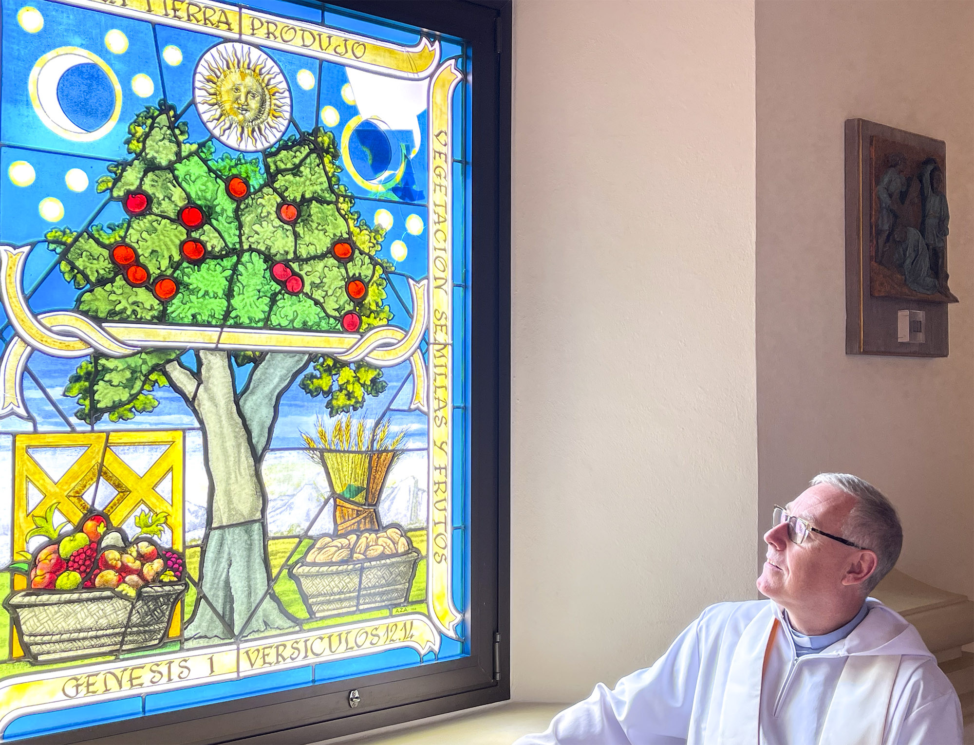 Reverend Dr. Tony Carroll contemplating the stained glass window of Sotogrande parish church © Michelle Chaplow