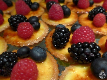 Fresh berries on bite sized custard tarts. © Michelle Chaplow