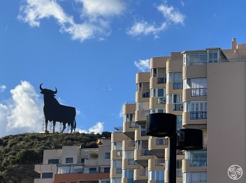 Contemporary architecture with the Osbourne Bull standing around on the hill top in Torreblanca      © Michelle Chaplow