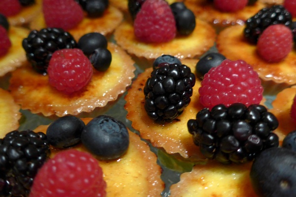 Fresh berries on bite sized custard tarts. © Michelle Chaplow