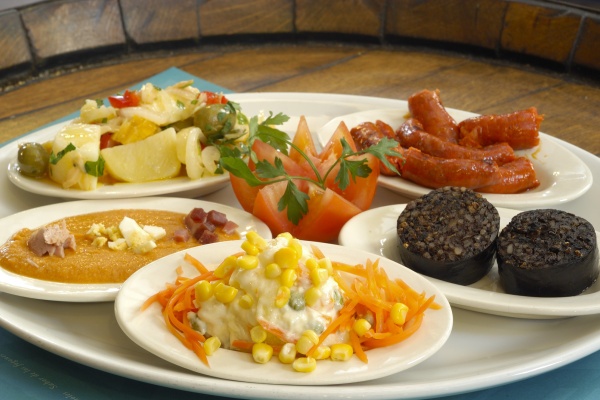 Five very popular traditional Spanish tapas are salmorejo (salmorejo), chorizo (chorizo), Russian salad (ensalada rusa), blood sausage (morcilla), Iberian sausages (embutidos ibéricos), and potato salad (ensalada de patatas). © Michelle Chaplow