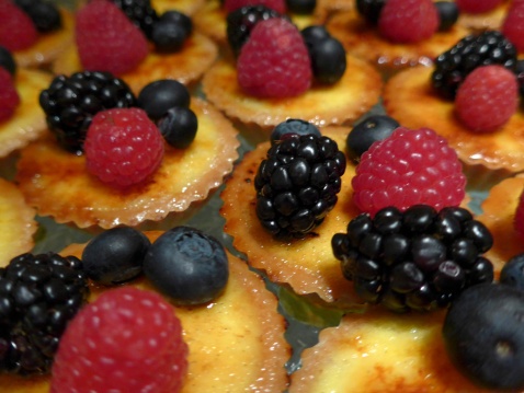 Fresh berries on bite sized custard tarts. © Michelle Chaplow