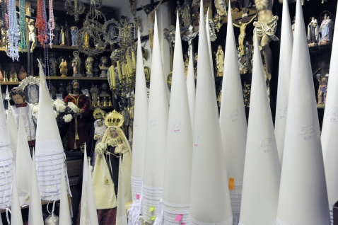 Cone-shaped inner moulds for the tall, pointed headwear of the Nazarenos are stacked in corners, their sizes and heights marked in pencil and tagged with handwritten Post-its—a system charming in its simplicity. Michelle Chaplow