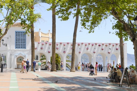 Arches bathed in sunlight, flower pots in bloom — Nerja’s Balcón de Europa © Michelle Chaplow