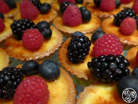Fresh berries on bite sized custard tarts. © Michelle Chaplow