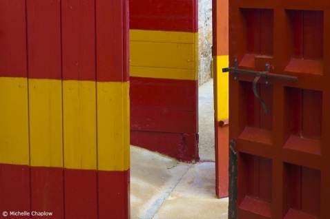 The emblematic red and yellow doors of Spain´s bullrings © Michelle Chaplow