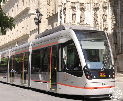 A tram passing Seville Cathedral through centuries of history. © Michelle Chaplow