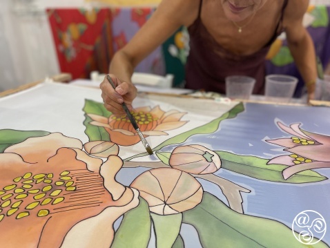 Silvia Ramos hand painting floral designs on silk. © Artist