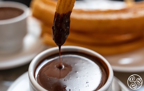 Chocolate Y Churros (spiral shaped deep fried doughnuts) and hot chocolate for dunking. Chocolate Y Churros (spiral shaped deep fried doughnuts) and hot chocolate for dunking.