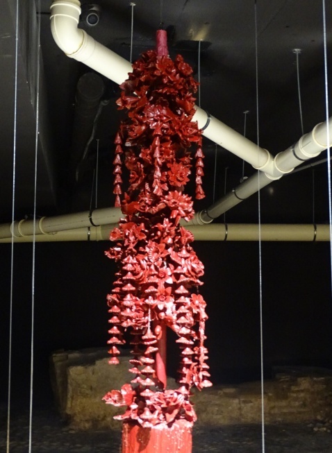 Red candle with carved flowers and hanging details. Red candle with carved flowers and hanging details. © Fiona Flores-Watson